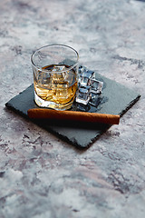 Image showing Glass of whiskey with ice cubes and cigar