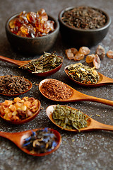 Image showing Spoons with different types of dry tea leaves.