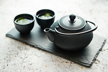 Image showing Traditional eastern metal teapot and iron cups