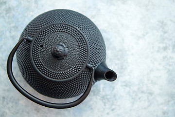 Image showing Black metal oriental teapot isolated