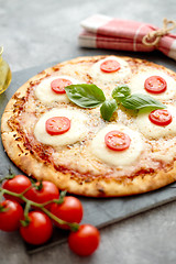 Image showing Homemade pizza with tomatoes, mozzarella