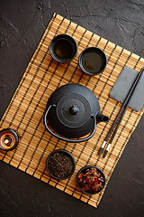 Image showing Asian green tea set on bamboo mat