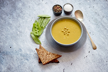 Image showing Green pea cream soup in grey bowl