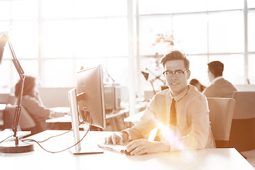 Image showing Young businessman using computer at work