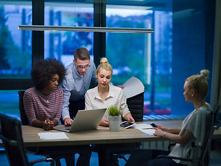 Image showing Multiethnic startup business team in night office