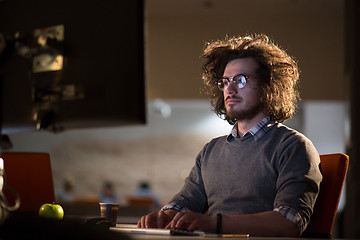 Image showing man working on computer in dark office