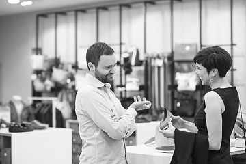 Image showing couple chooses shoes At Shoe Store