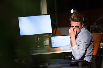 Image showing man working on computer in dark office