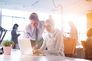 Image showing Young businessman helping his colleague at the work