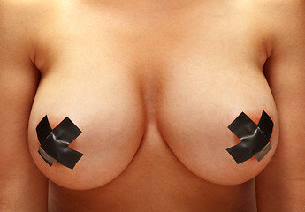 Image showing female breast with black bondage