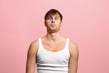 Image showing The squint eyed man with weird expression isolated on pink