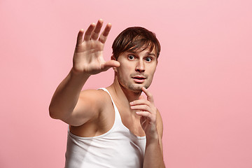 Image showing Portrait of the scared man on pink