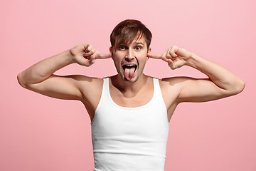 Image showing The squint eyed man with weird expression isolated on pink