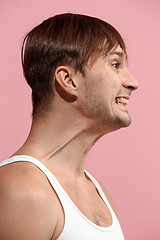 Image showing Handsome man looking suprised isolated on pink