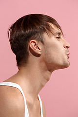 Image showing Portrait of attractive man with kiss isolated over pink background