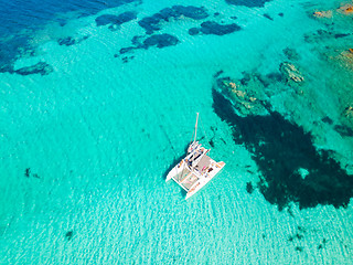 Image showing Drone aerial view of catamaran sailing boat in Maddalena Archipelago, Sardinia, Italy.