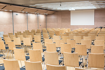 Image showing Empty wooden seats in a cotmporary lecture hall.