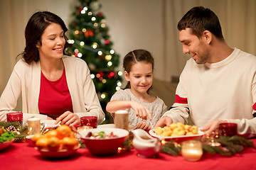 Image showing happy family having christmas dinner at home