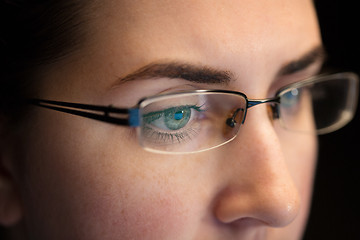 Image showing close up of woman in glasses looking at screen