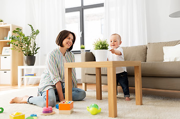 Image showing happy mother with little baby boy playing at home