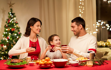 Image showing happy family having christmas dinner at home