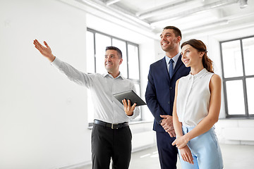 Image showing realtor with tablet pc showing office to customers