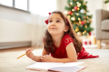 Image showing little girl making christmas wish list at home