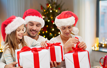 Image showing happy family with christmas gifts at home