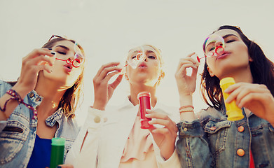 Image showing young women or girls blowing bubbles outdoors