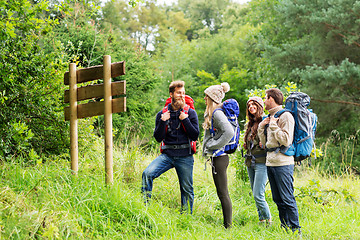 Image showing hiking friends with backpacks at signpost