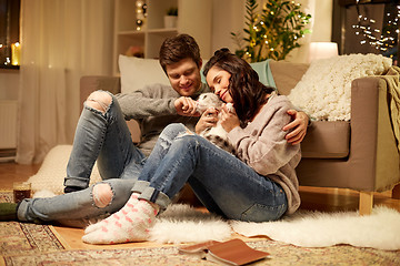 Image showing happy couple with cat at home