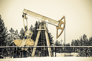 Image showing Pump jack situated in forest.