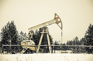 Image showing Pump jack situated in forest.