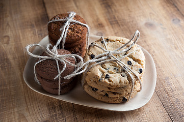 Image showing Shortbread, oat cookies, chocolate chip biscuit on wooden background.