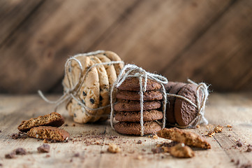 Image showing shortbread, oat cookies, chocolate chip biscuit on wooden background.