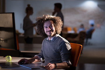 Image showing man working on computer in dark office