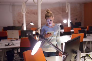 Image showing woman working on digital tablet in night office