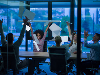 Image showing multiethnic Group of young business people throwing documents