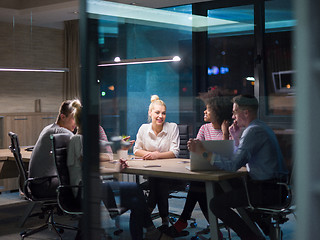 Image showing Multiethnic startup business team in night office