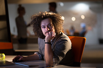 Image showing man working on computer in dark office