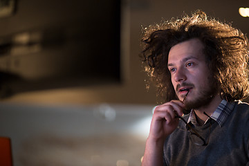 Image showing man working on computer in dark office