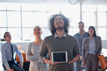 Image showing Portrait of a young businessman holding tablet