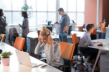 Image showing businesswoman using a laptop in startup office