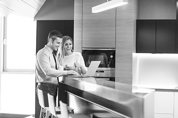 Image showing A young couple is preparing for a job and using a laptop