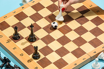 Image showing soccer ball of chess pieces on the board