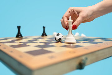 Image showing soccer ball of chess pieces on the board