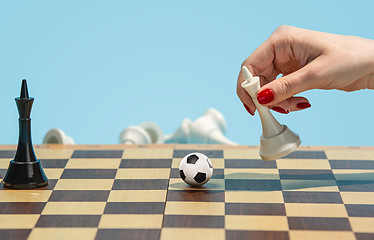 Image showing soccer ball of chess pieces on the board