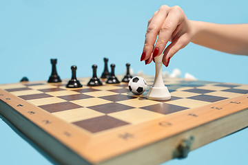 Image showing soccer ball of chess pieces on the board