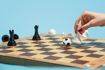 Image showing soccer ball of chess pieces on the board