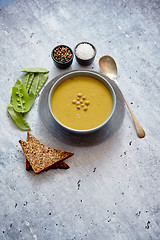 Image showing Green pea cream soup in grey bowl